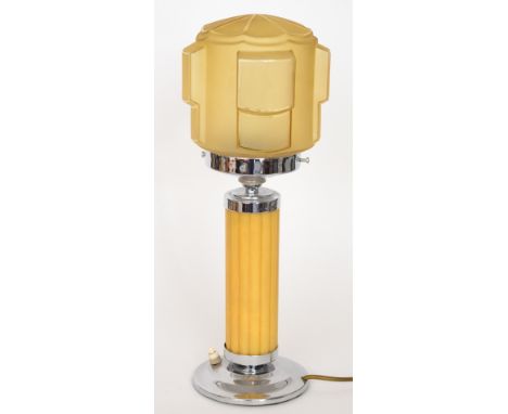 Unknown - An Art Deco table lamp with a stepped circular brass foot rising to a fluted amber phenolic column with chrome gall