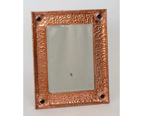 English School - A planished rectangular copper wall mirror detailed with four blue Ruskin Pottery style roundels to each cor