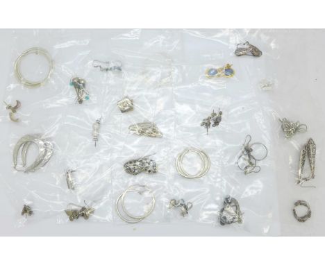 A collection of silver earrings 