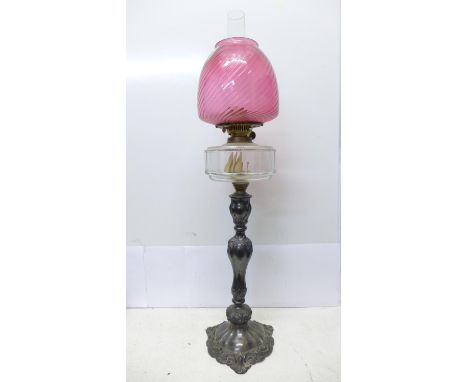 A large silver table lamp with cranberry glass shade 