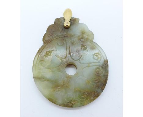 A jade pendant with yellow metal loop 
