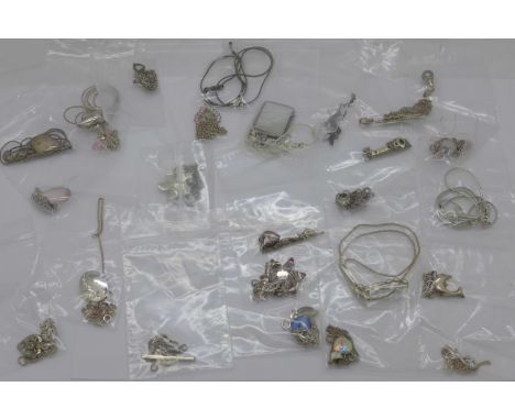 Twenty five silver pendants and chains 