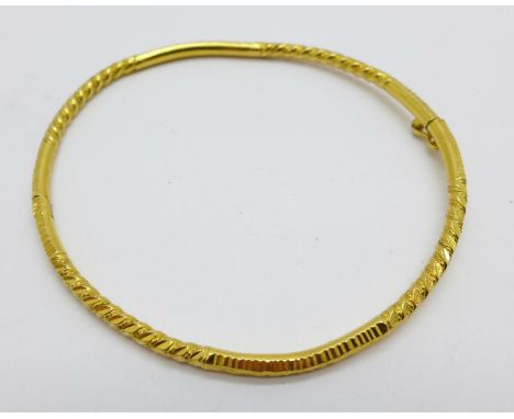 A yellow metal bangle marked 916, (22ct), 13.1g 