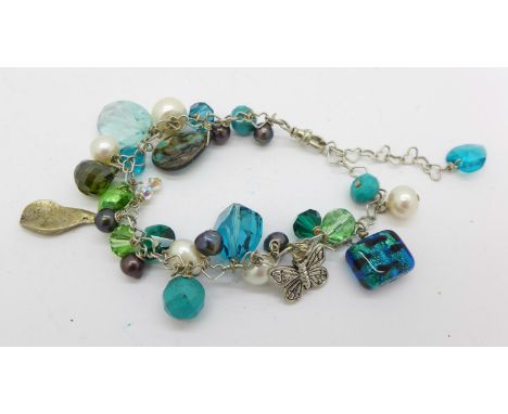 A silver and stone set charm bracelet 