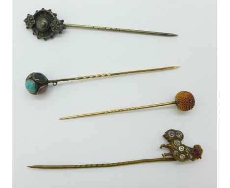 Four assorted stick pins including yellow metal 