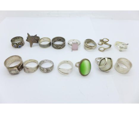 Fourteen silver rings and a plated ring 