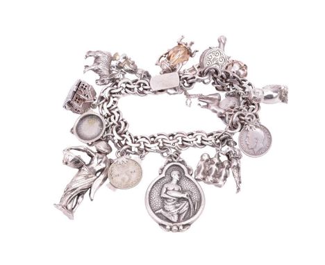 A silver charm bracelet with eighteen assorted charms and fobs including an owl, a stag, a country musician with a guitar, a 
