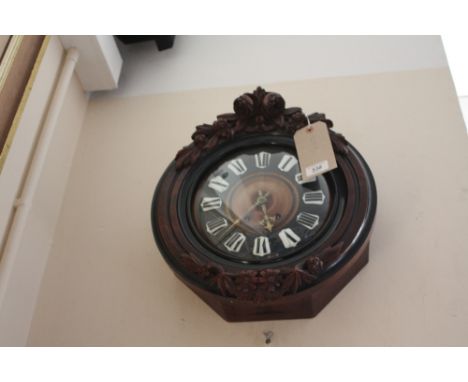 A late 19th century French wall clock, with carved walnut case, the dial with ebonisied chapter ring and enamel Roman numeral