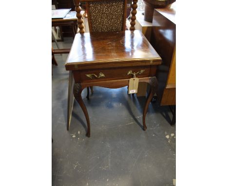 An Edwardian mahogany envelope card table, the square top above a drawer, on cabriole legs, W. 55cm.