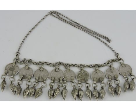 An Azarbaijani white metal necklace, set with Russian coins and husk shaped drops, on a ladder link type chain, 3ozt. 