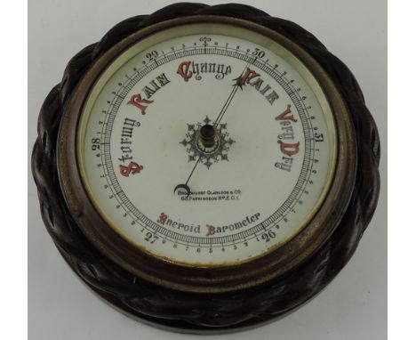 An early 20th century aneroid barometer by Broadhurst and Clarkson, the silvered dial within a carved oak rope-work frame,D. 