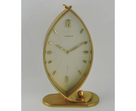 A Jaeger le Coultre brass cased mantel timepiece, navette shaped with  silvered dial set out in Arabic and baton numerals, fi