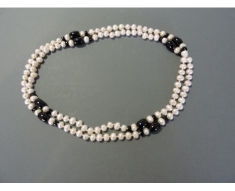 An opera length string of freshwater pearl with onyx, L. 140cm.