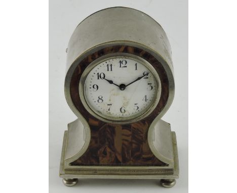 An Art Deco style mantle clock, the balloon-shaped case with tortoiseshell effect front, the white enamel dial set out in Ara