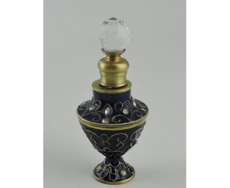 A brass and blue enamel scent bottle, urn shaped with a faceted crystal stopper, H. 10cm.