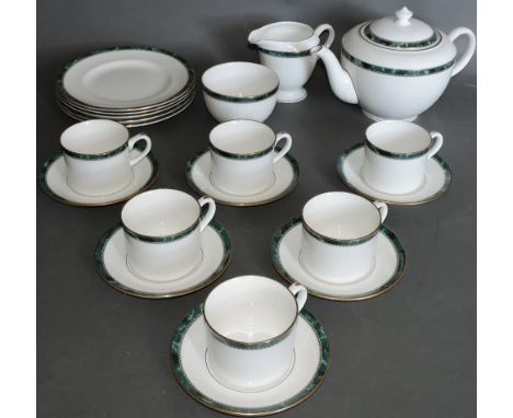 A Royal Worcester tea service, six place settings including cups, saucers, plates, milk jug and sucriere, decorated with a a 