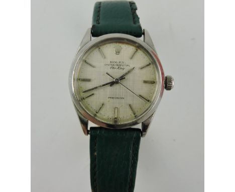 A Rolex Air-King gentlemen's automatic wristwatch, with a steel case and baton numerals on a silvered dial, on an associate g