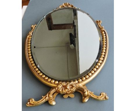 An oval gilt framed dressing table mirror together with a satirical print and three further prints