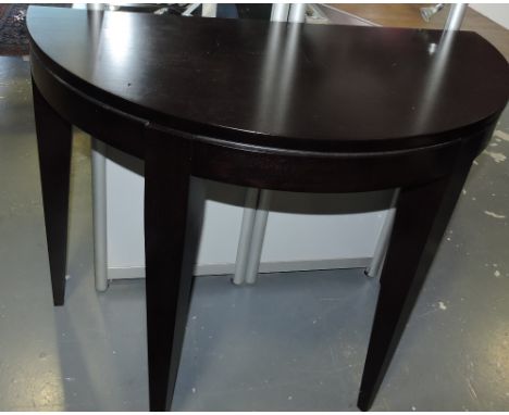 A designer ebonized demi lune console table on square tapered legs, W:92cm