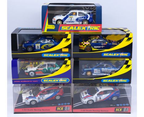 Scalextric/SCX, a group of 1:32nd scale Slot Racing Cars to include (1) C2171 Ford Escort; (2) C2243 Subaru - Barretts; (3) C