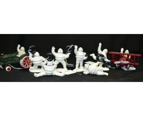 A cast metal figure of a Michelin plane, tractor and men
