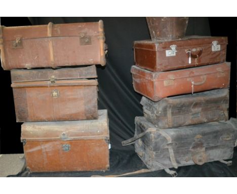 A large brown leather travelling trunk, early 20th century; other similar vintage luggage, two metal dome topped trunks, a br