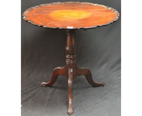 A 19th century mahogany shaped circular tripod supper table, tilting top with pie crust border, turned column, cabriole legs 