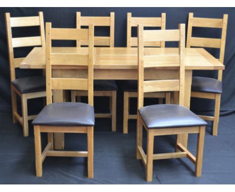 A modern light oak rectangular extending dining table and six ladder back chairs