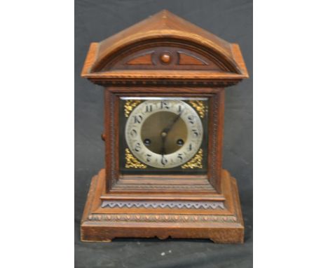 A late 19th century oak bracket clock, silvered chapter ring inscribed with Arabic numerals, twin winding holes, eight-day mo