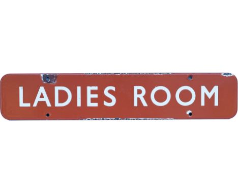 BR(NE) enamel doorplate LADIES ROOM. In good condition with some edge chipping and a few face chips. Measures 18in x 3.5in. 