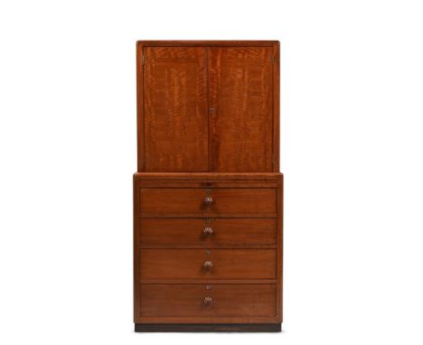 BETTY JOEL (BRITISH, 1894-1985) A COCKTAIL CABINET ON CHEST; MADE BY TOKEN WORKS, 1938 Walnut; internal glass shelf, glass pu
