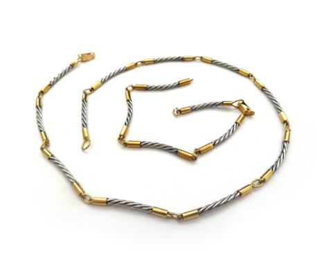 A gold bi-coloured necklace and bracelet, each in a curved baton shaped link design, with a folding clasp, detailed Gregory 1