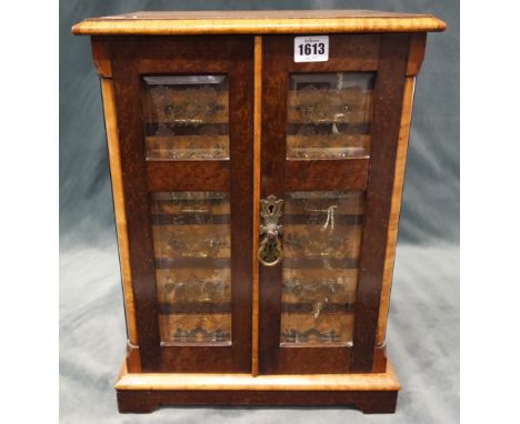 A Victorian bird's eye maple table top collector's cabinet, the pair of double panel bevelled glazed doors enclosing seven gr
