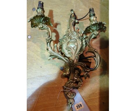 Lighting comprising; a group of six 20th century gilt metal twin branch wall lights of Rococo style, (6).     I10