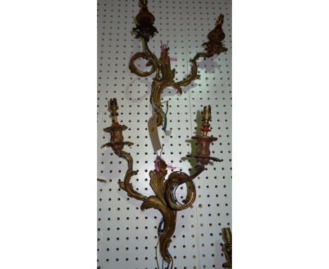 Lighting comprising; a group of three similar 20th century gilt metal twin branch wall lights, (3).