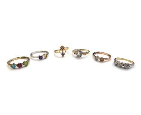 A gold and diamond set three stone ring, mounted with circular cut diamonds, a gold and diamond set ring, in a pierced design