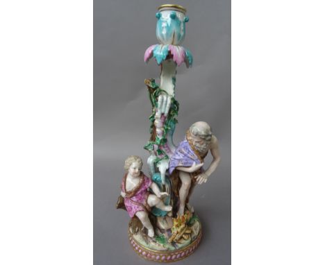 A Meissen  porcelain figural candlestick, 19th century, emblematic of Winter, modelled with an old man wearing a fur lined cl