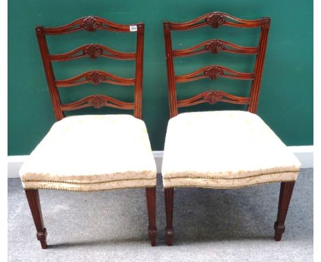 A set of six George II style mahogany shell carved wavy ladder back dining chairs, on fluted tapering square supports, each 5
