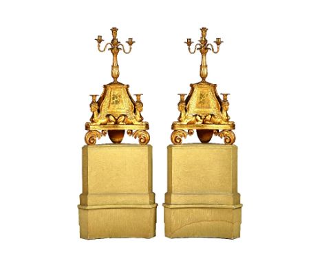 A pair of Italian Neo-Classical giltwood corner candelabra, circa 1820, each with four branch surmount over a foliate carved 
