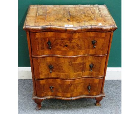 A small 18th century German walnut commode, with three serpentine drawers on later squat cabriole supports, 60cm wide x 78cm 