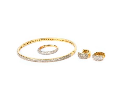 An 18ct gold and diamond set oval hinged bangle, the front pave set with small circular cut diamonds, on a snap clasp, an 18c