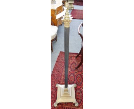 A Victorian brass adjustable standard lamp, of Corinthian column form, on a stepped square base and four lion paw feet, toget