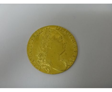 A George III guinea, 4th head 1774, with Spink & Son ticket, detailed Property of Dr Vooglaar.   Illustrated
