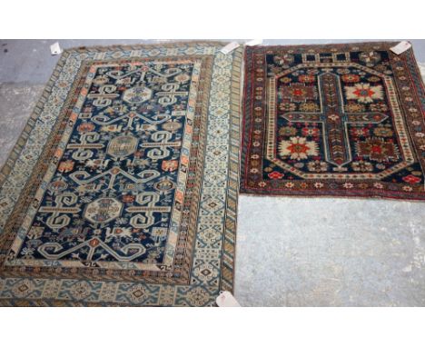 A Perepedil rug, Caucasian, the indigo field with four sets of horns, pairs of peacocks and minor motifs, a diamond and brack