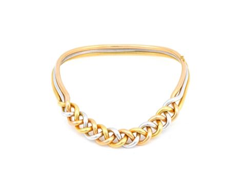 A three colour gold demi parure, comprising; a collar necklace, an oval hinged bangle and a pair of trefoil shaped earclips, 