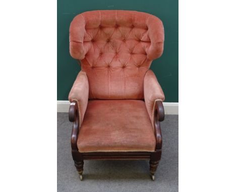 An early Victorian mahogany framed wingback armchair, with integral footstool in the manner of Dawes, pale pink button uphols