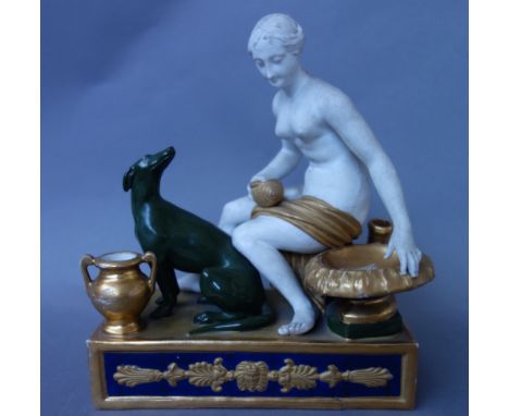 A Paris porcelain figural inkwell, 19th century, modelled with a naked female and greyhound, on a foliate moulded rectangular