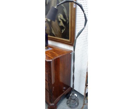 A copper coloured metal floor lamp in the manner of Edgar Brandt, of beaten sectional form with foliate embellished base, 168