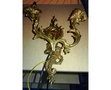 Lighting comprising; a group of five 20th century gilt metal twin branch wall lights of Rococo style, (5).     I10