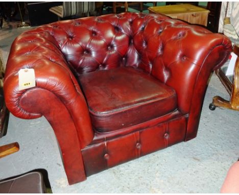 A 20th century button back red leather club armchair.  I5